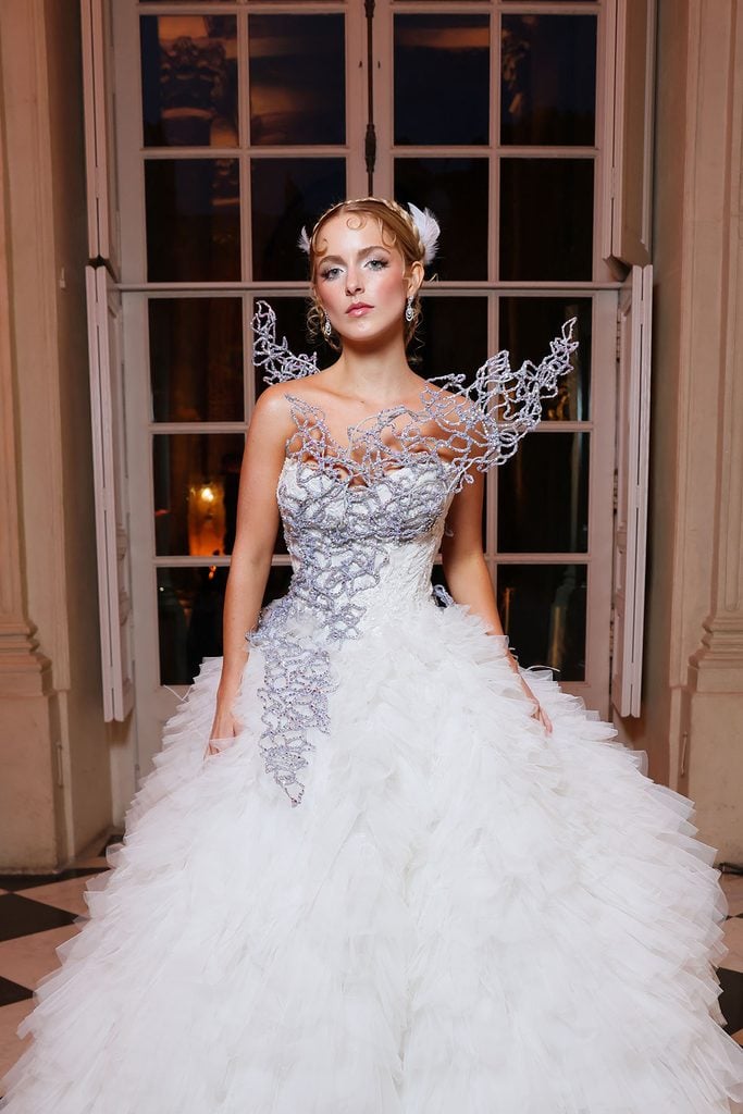 Mckenna Grace in a Monique Lhuillier gown featuring silver sculptural embellishment at the Hunger Games event in Paris.
