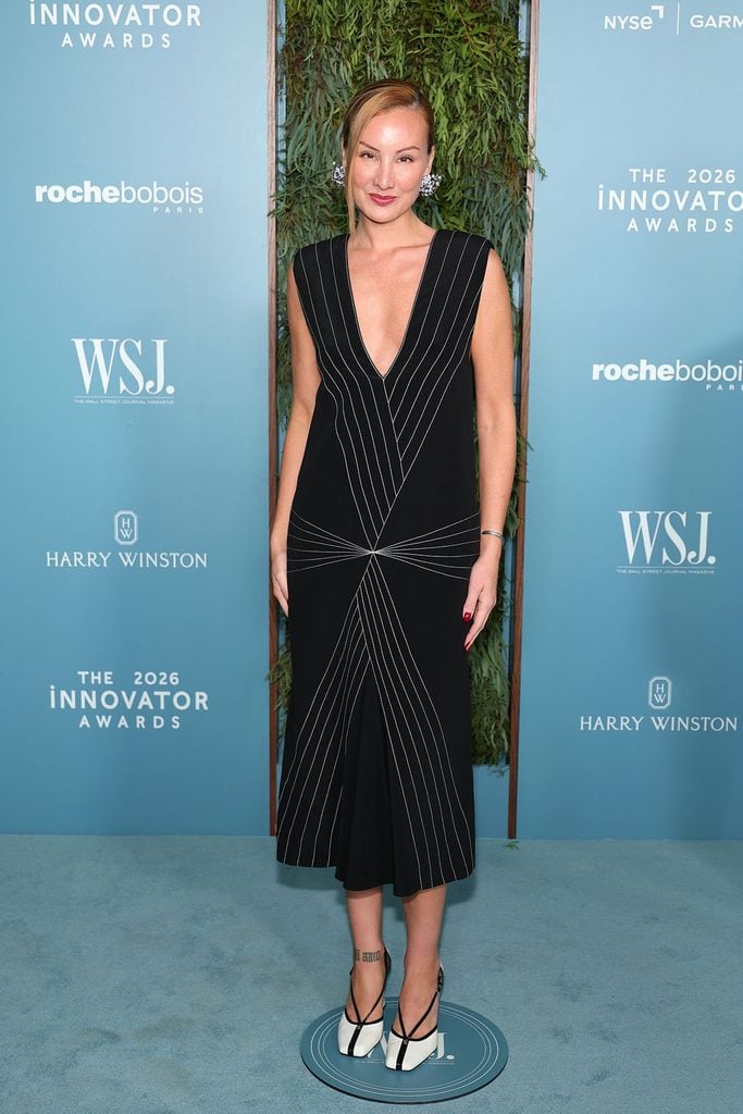 Miyako Bellizzi wears a black Chanel Resort 2027 dress with a plunging neckline, contrasting stitched lines and black-and-white slingback shoes at the 2026 WSJ. Magazine Innovator Awards.