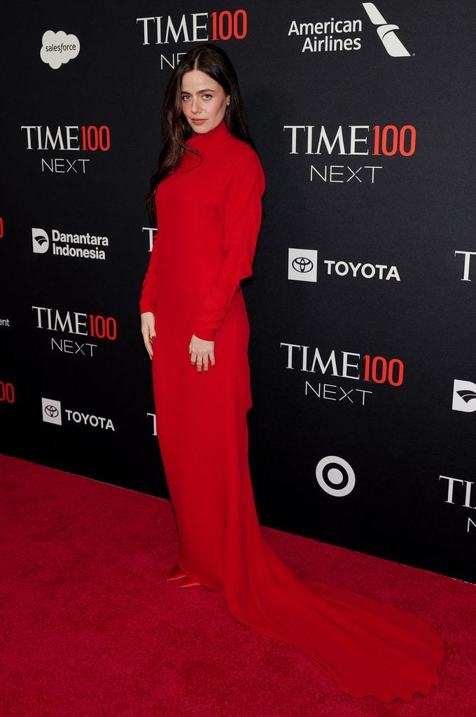 Molly Gordon wears a long-sleeved red Valentino Fall 2026 gown with a high neckline and sweeping train at the 2026 TIME100 Next Gala.