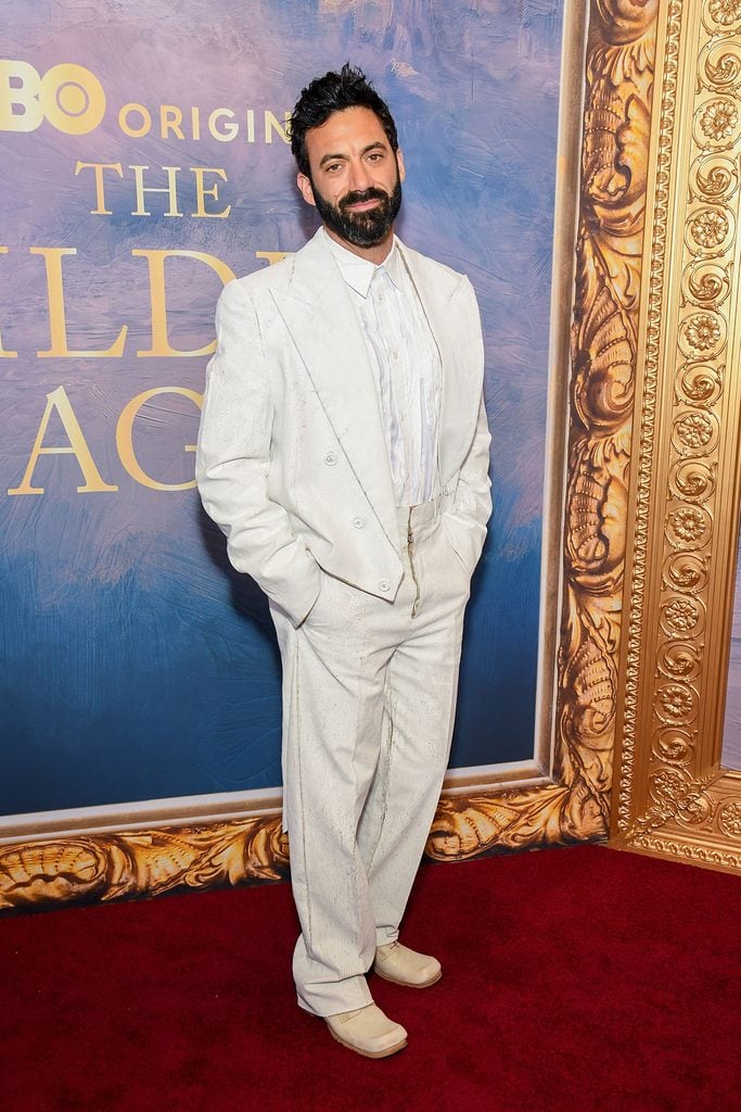 Morgan Spector in a white Maison Margiela Fall 2026 Bianchetto-painted suit with an Edwardian-style tailcoat at The Gilded Age premiere in New York.