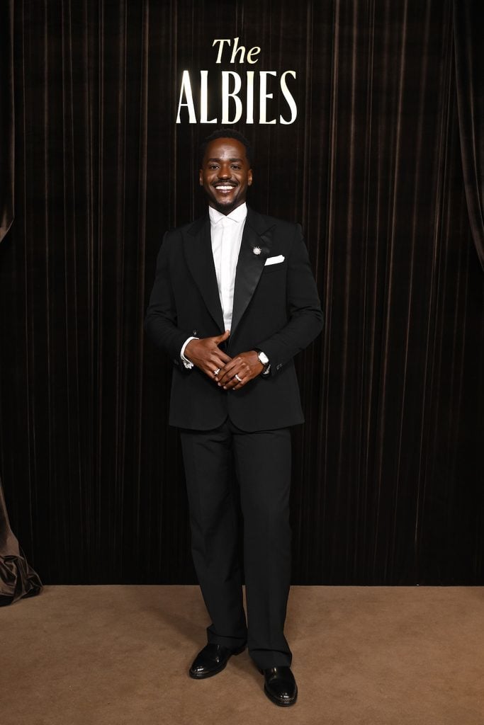 Ncuti Gatwa wearing black evening tailoring with a Tiffany & Co. Apollo diamond brooch at the 2026 Albies in London