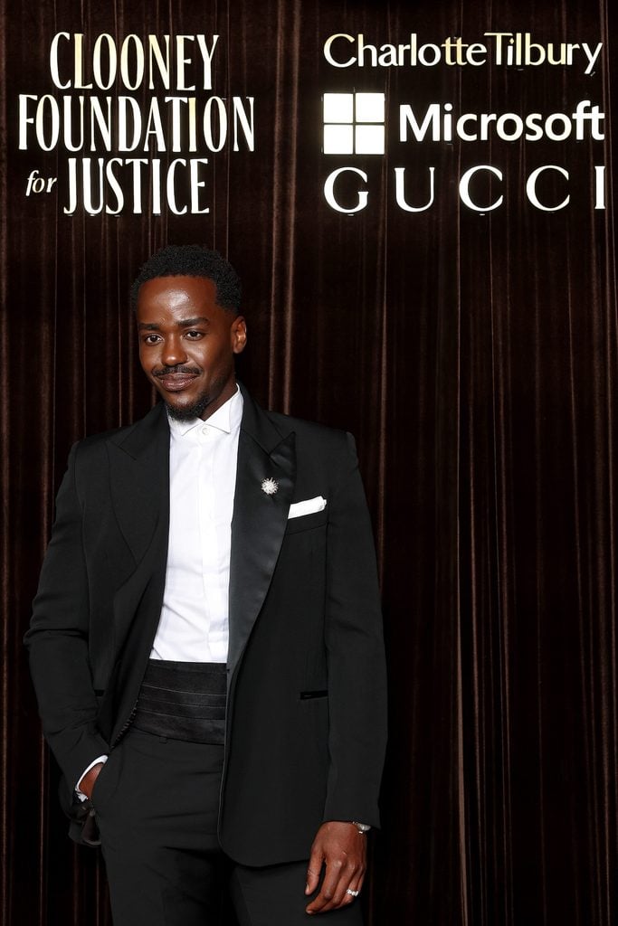 Close up of Ncuti Gatwa wearing black evening tailoring with a Tiffany & Co. Apollo diamond brooch at the 2026 Albies in London