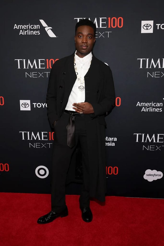 Paapa Essiedu wears a black Armani longline coat with a white stand-collar shirt, satin waist tie and David Webb necklace at the 2026 TIME100 Next Gala.