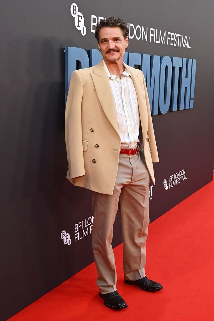 Pedro Pascal wearing a beige Chanel double-breasted jacket with grey trousers and a red belt at the 'Behemoth!' BFI London Film Festival premiere.