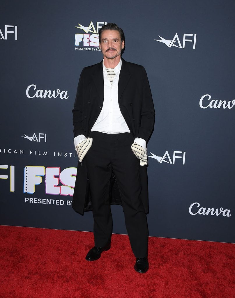 Pedro Pascal wears a Prada Fall 2026 black double-breasted coat with exaggerated striped cuffs at the AFI FEST screening of Behemoth in Hollywood.