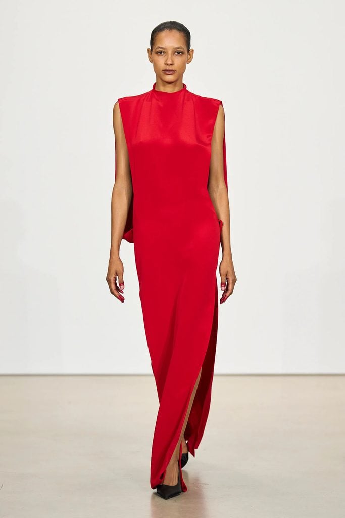 Model wearing Caitríona Balfe’s red mock-neck dress on the Prabal Gurung Spring 2027 runway.