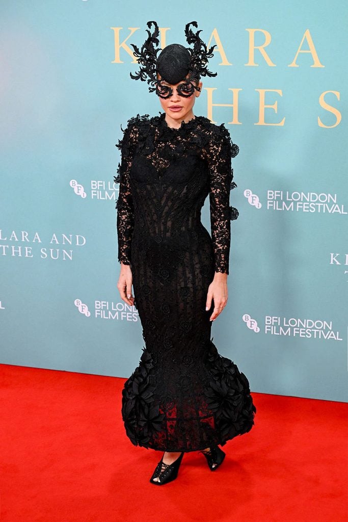 Rita Ora in a black ArdAzAei couture lace gown with an elaborate Philip Treacy headpiece at the 2026 BFI London Film Festival