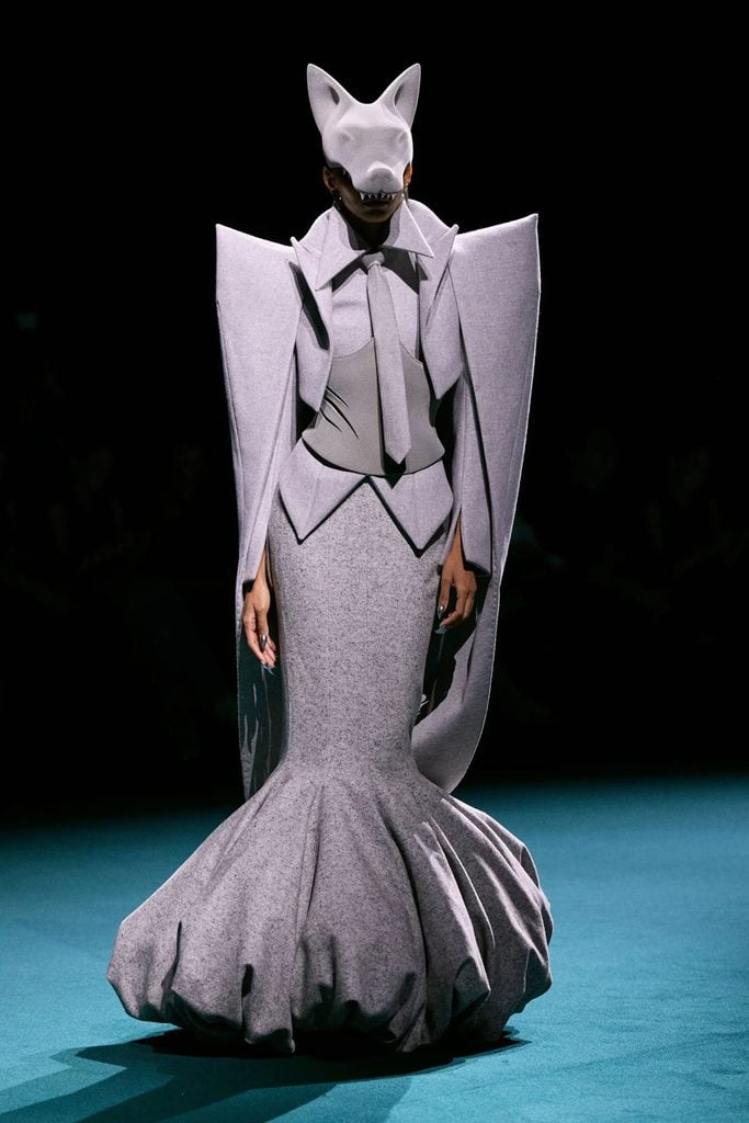 Robert Wun Fall 2026 Couture runway look featuring an architectural grey gown, exaggerated shoulders and a matching wolf headpiece.