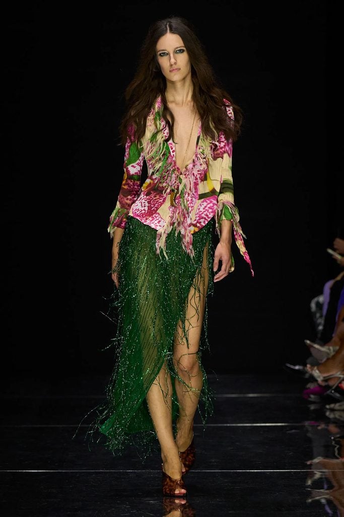 Roberto Cavalli Spring 2027 runway model wears the floral 'Orchidea' print top and emerald-green fringed skirt later worn by Beyoncé at JAY-Z's anniversary concert.