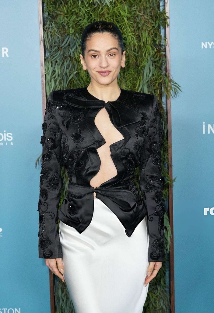Close-up of Rosalía wearing Schiaparelli's black Elsa jacket, highlighting the satin bows, asymmetric cut-outs and intricate tonal beadwork at the 2026 WSJ. Magazine Innovator Awards.