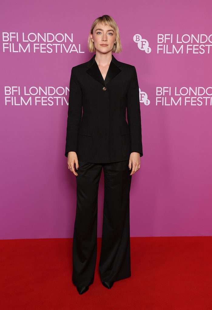 Saoirse Ronan in a black Louis Vuitton suit with satin lapels and wide-leg trousers on the red carpet at the 2026 BFI London Film Festival