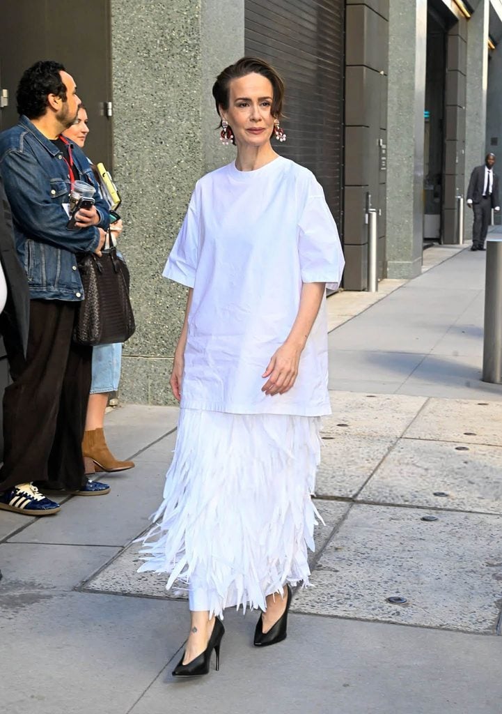Sarah Paulson wearing an oversized white Balenciaga T-shirt, feathered skirt and black pumps while promoting 'American Horror Story: 13' in New York.