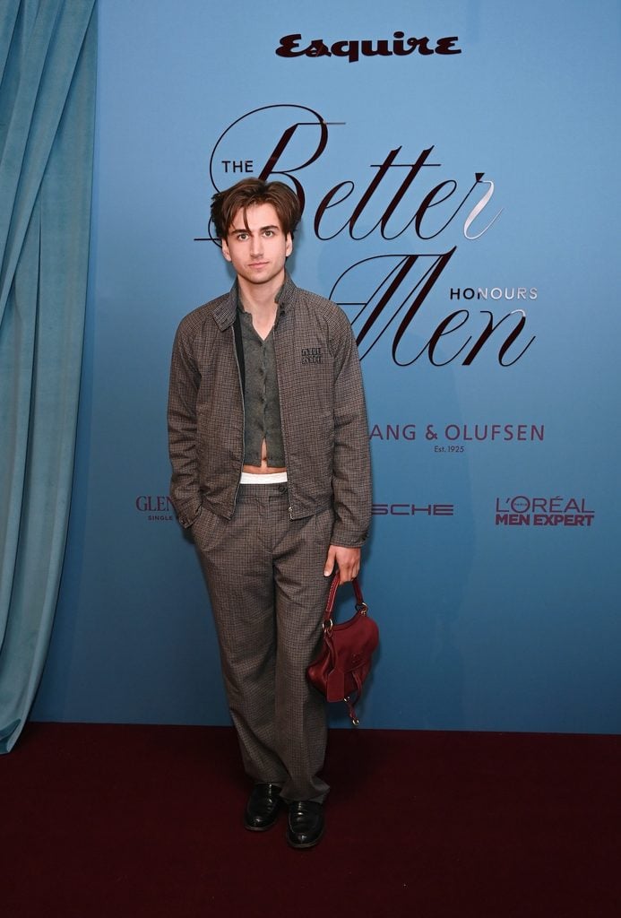 Sebastian Croft wearing a Miu Miu checked ensemble with a cropped cardigan and exposed underwear at Esquire UK's Better Men Honours in London.