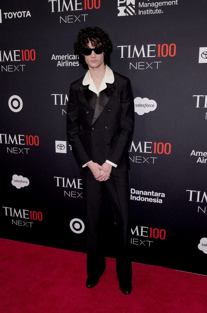 Sombr wears a Valentino by Alessandro Michele black double-breasted suit with a contrasting ivory collar and sunglasses at the 2026 TIME100 Next Gala.