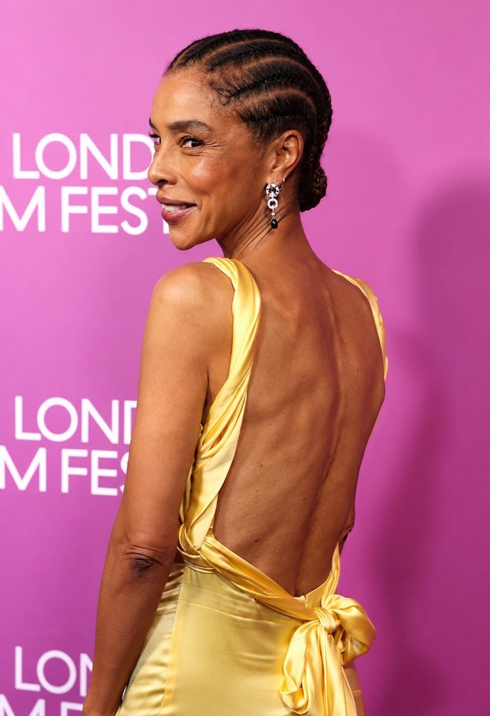 Sophie Okonedo showing the open back and bow detail of her yellow Prada gown at the 'Clarissa' premiere in London.