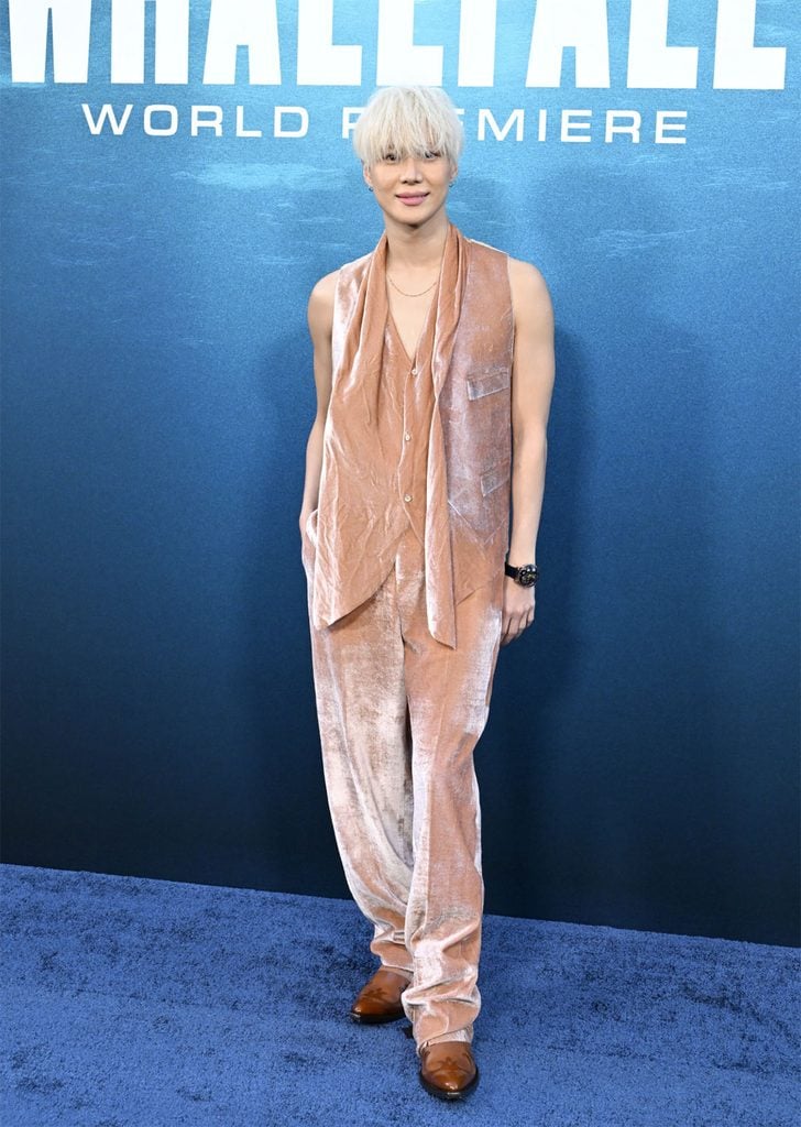 Taemin wearing a peach velvet Maison Margiela Fall 2026 waistcoat and trousers with caramel Western boots at the 'Whalefall' Los Angeles premiere.