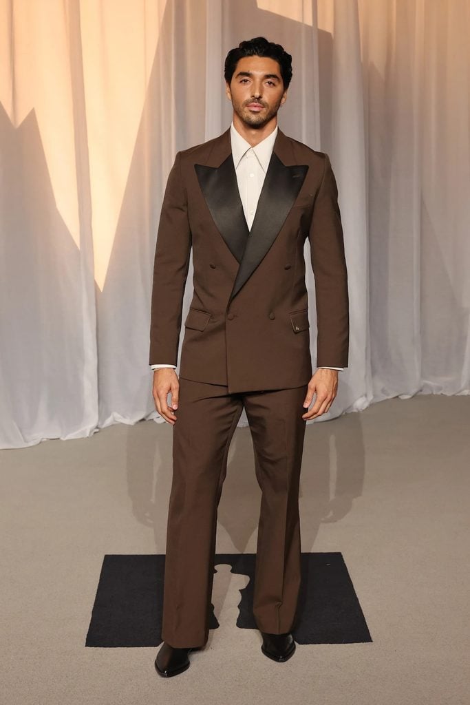 Taylor Zakhar Perez wearing a custom Amiri brown double-breasted suit with black satin lapels at the 2026 Academy Museum Gala.