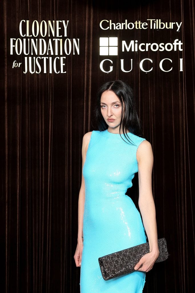 Tish Weinstock holding a black embellished clutch with her turquoise Gucci gown at the Clooney Foundation for Justice's 2026 Albies.