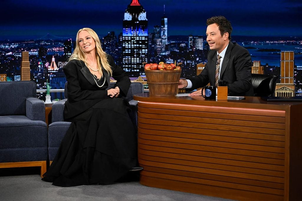 Uma Thurman wearing Aje Spring 2027 and layered pearl necklaces while speaking with Jimmy Fallon on The Tonight Show in New York.