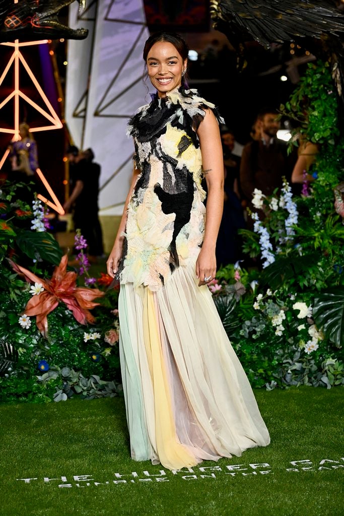 Whitney Peak wears a pastel Chanel Spring 2026 Haute Couture gown with black textured detailing and a pleated skirt at The Hunger Games: Sunrise on the Reaping London premiere.
