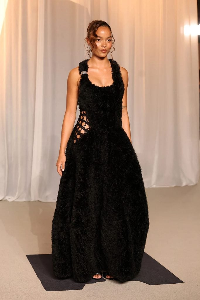 Whitney Peak in a textured black Diotima gown with openwork detailing at the waist at the 2026 Academy Museum Gala
