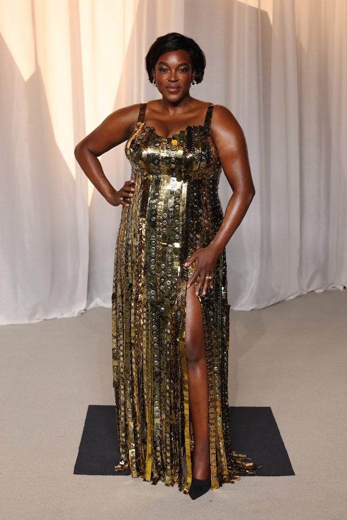Wunmi Mosaku wearing a metallic gold fringe-embroidered Louis Vuitton gown at the 2026 Academy Museum Gala