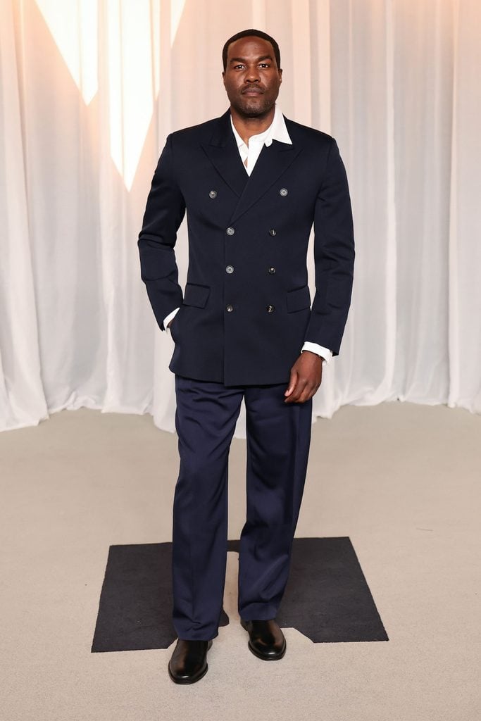 Yahya Abdul-Mateen II in a navy double-breasted Ferragamo suit and black Chelsea boots at the 2026 Academy Museum Gala
