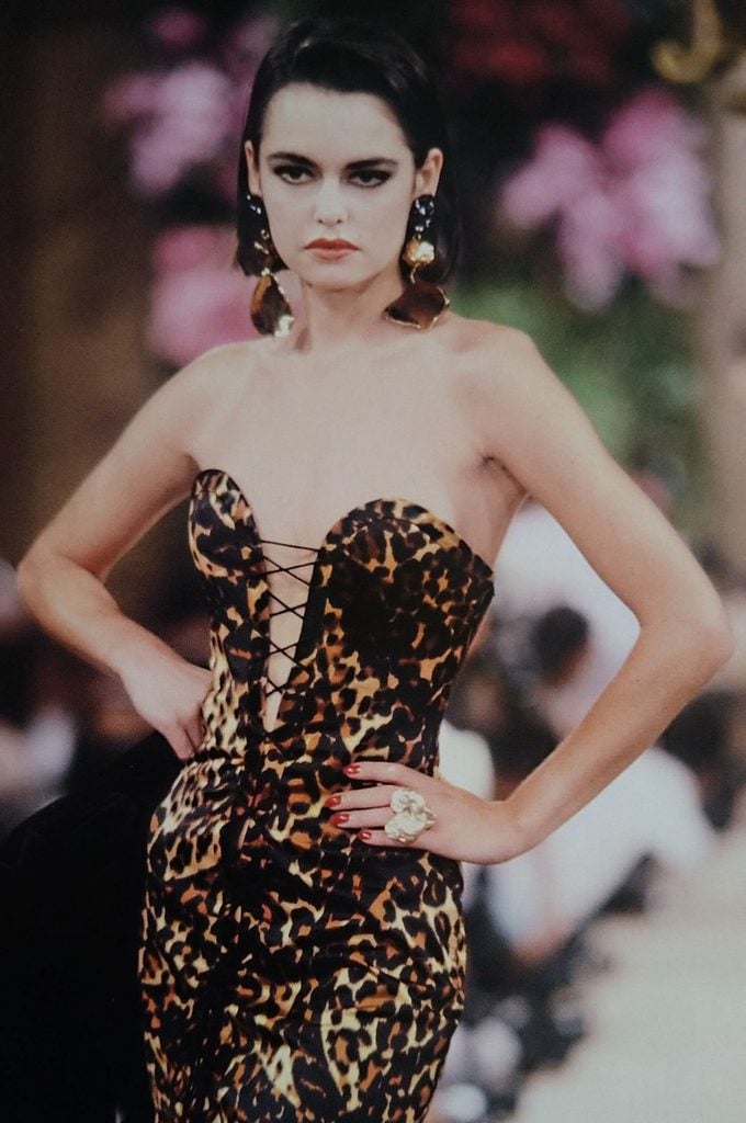 Runway model wears the original Yves Saint Laurent Autumn-Winter 1986–87 Haute Couture Golden Tigress gown with a lace-up leopard-print corset.